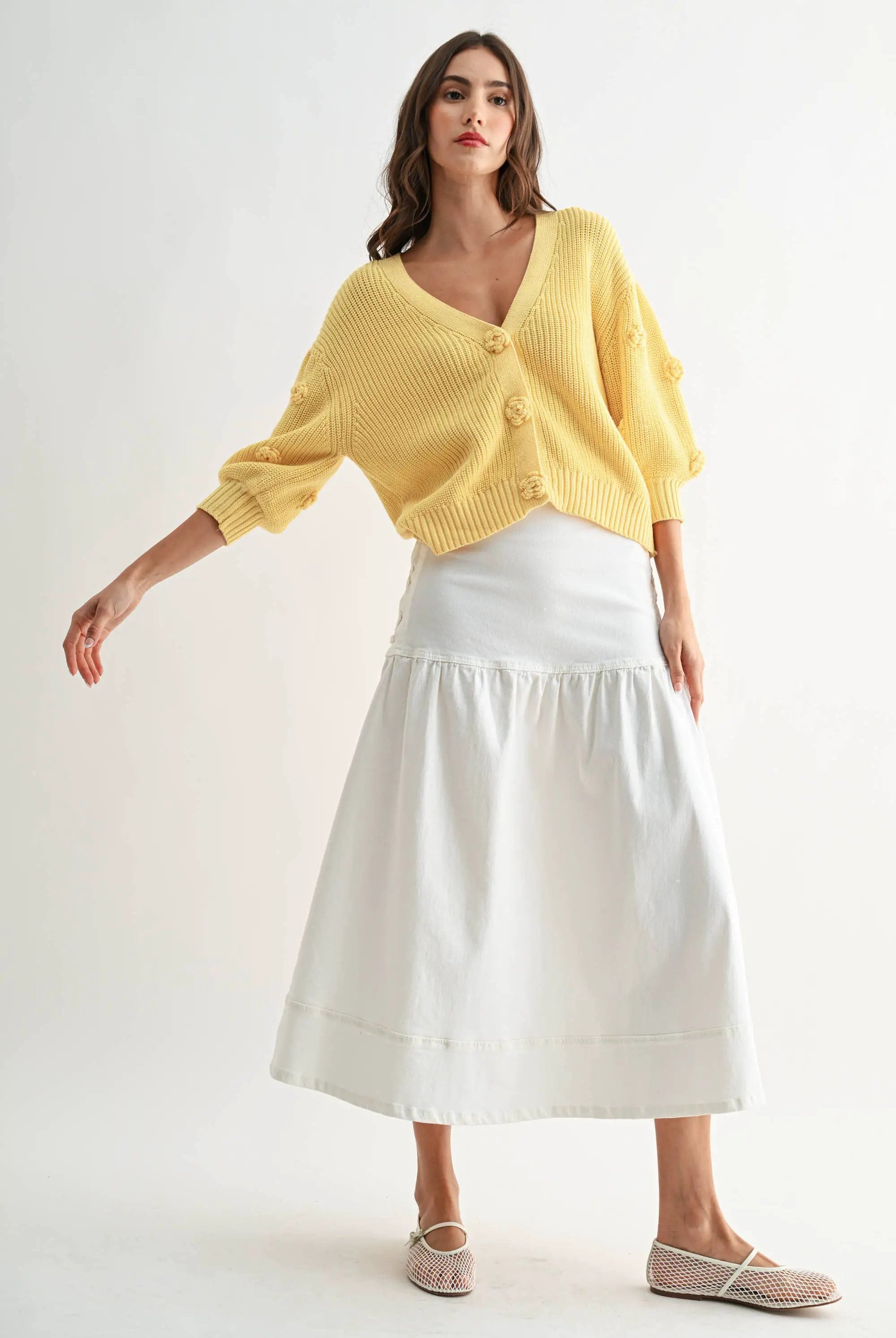 Model wearing LT.YELLOW textured knit cardigan with 3D button details.