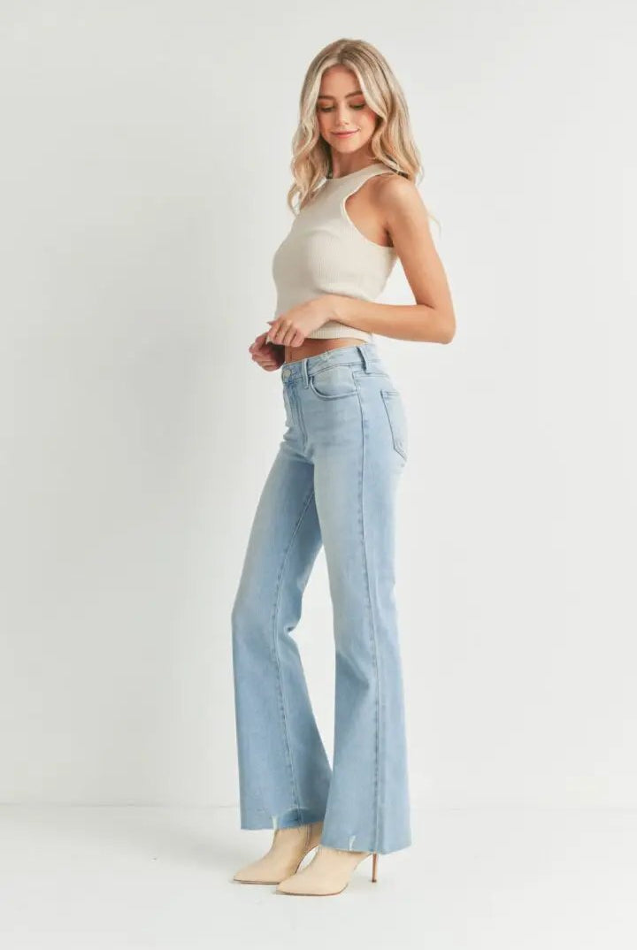 Light-wash Step Hem Flare Leg jeans with high-rise, cropped flare silhouette in soft stretch denim on a model.