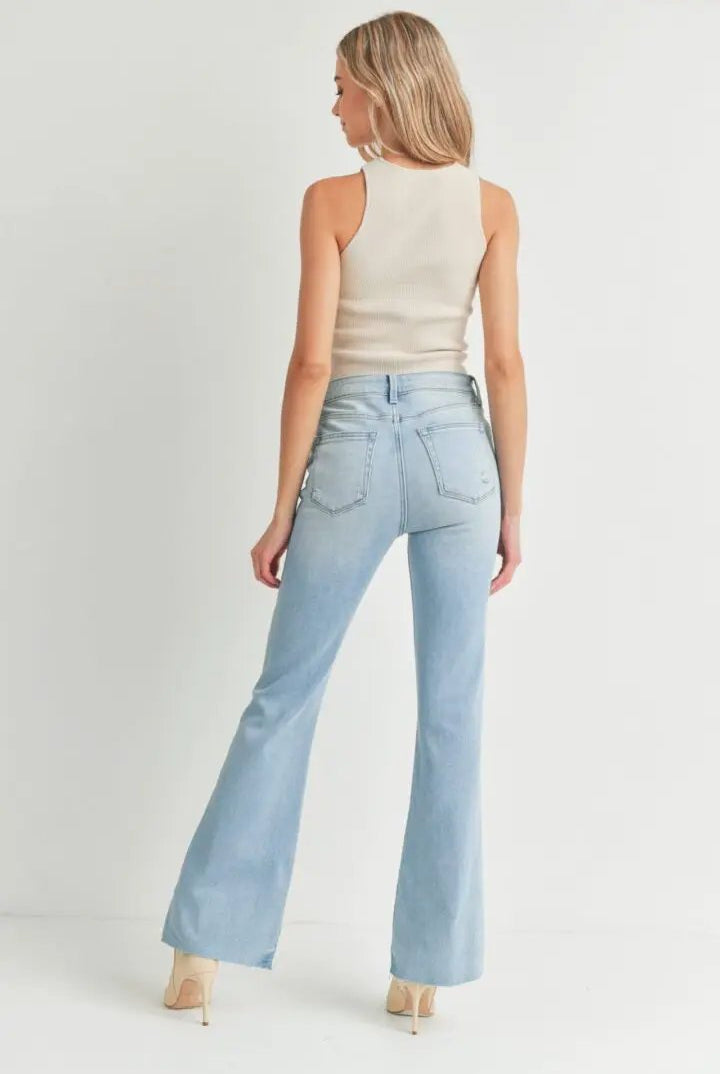 Back view of The Step Hem Flare Leg Light Wash Soft Stretch Denim Jeans with high-rise fit and back pockets.