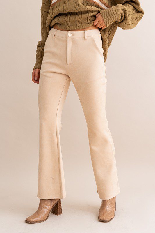 Beige suede flared pants and boots.