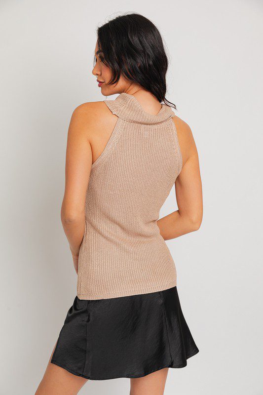 Beige sleeveless knit top and black skirt.