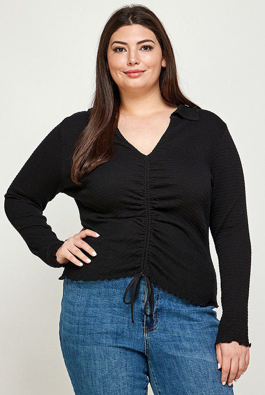 Plus-size black cinched long-sleeve top.
