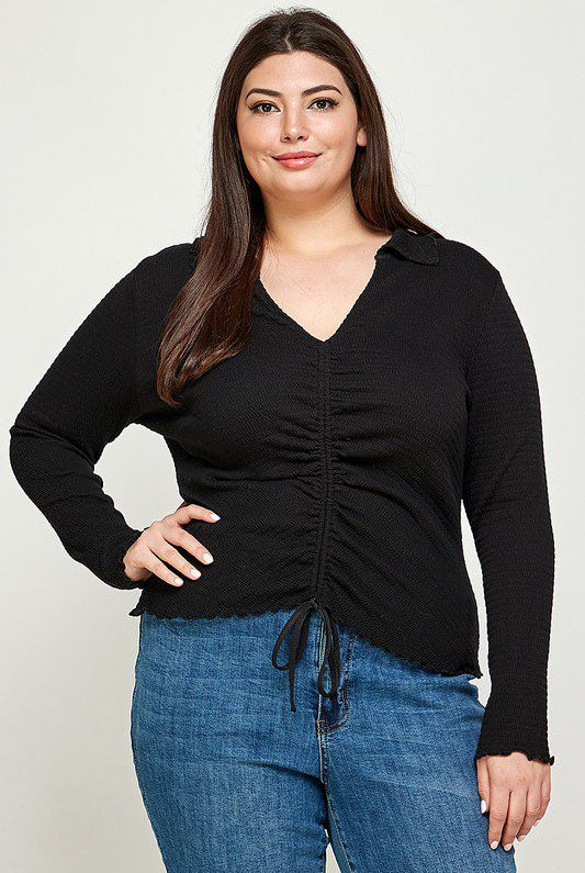 Plus-size black cinched long-sleeve top.