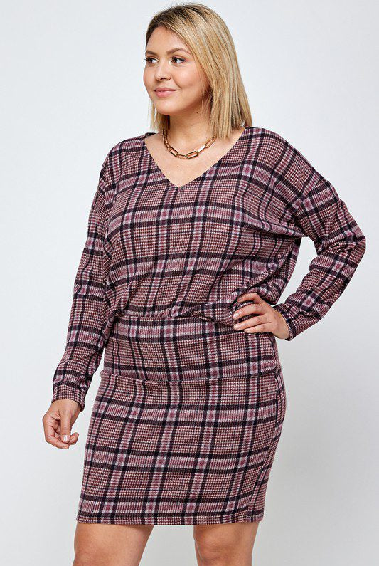 Plus-size model in plaid sweater and skirt.