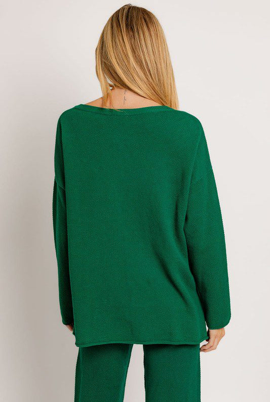 Here's an alt tag for the image: Green textured knit sweater and pants.