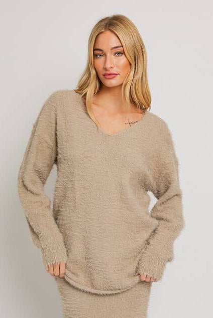 Woman in a beige fuzzy sweater.