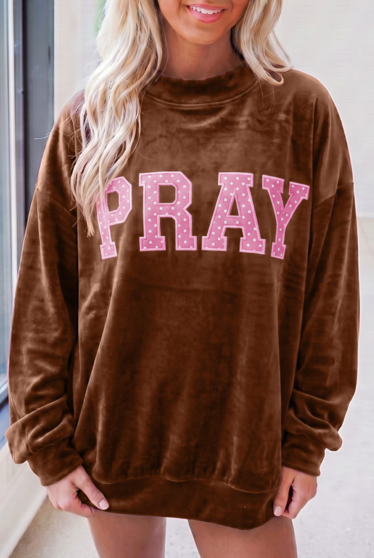 Brown velvet sweatshirt featuring PRAY in pink polka dot letters. Soft, coffee-colored Southern style top.