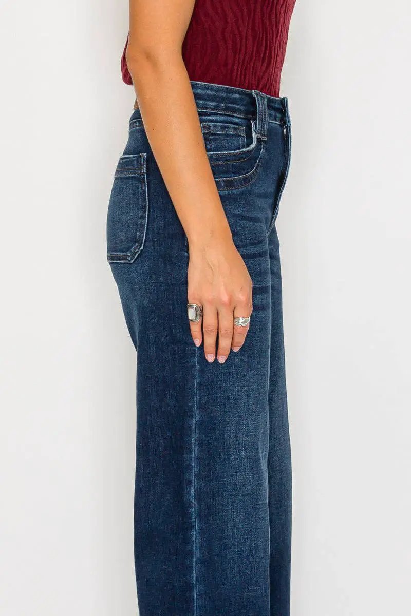 Artemis Vintage tummy-control high-rise A-line wide-leg jeans in dark stone wash, side view.