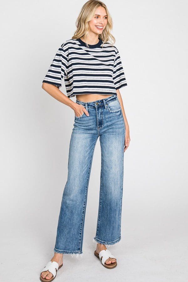 A woman wearing jeans and a striped shirt.