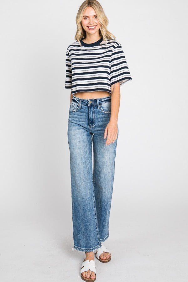 A woman wearing jeans and a striped shirt.