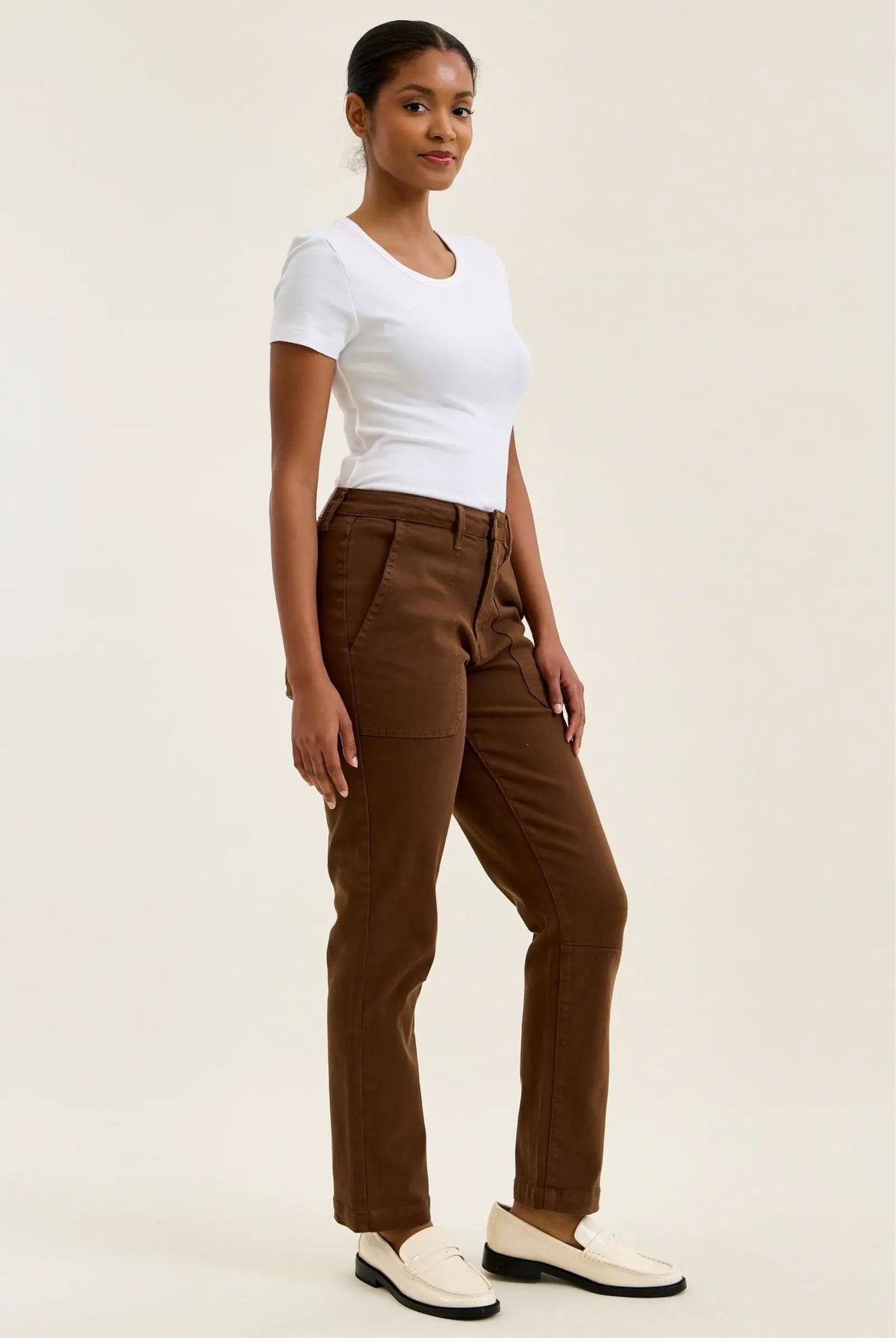 High-waist mahogany stretch jeans with a slim straight leg, fitted top block, and double-rolled cuff for a tailored silhouette.
