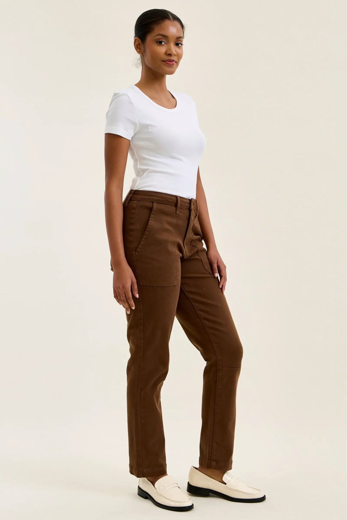 High-waist mahogany stretch jeans with a slim straight leg, fitted top block, and double-rolled cuff for a tailored silhouette.