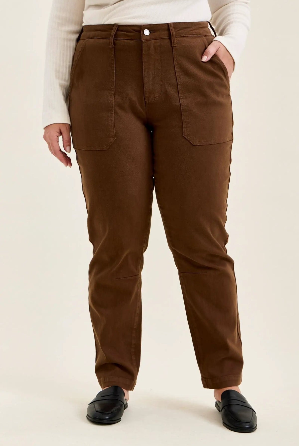 Mahogany high-waist plus size jeans featuring slim-straight legs, large utility pockets, and double-rolled cuffs paired with black loafers.