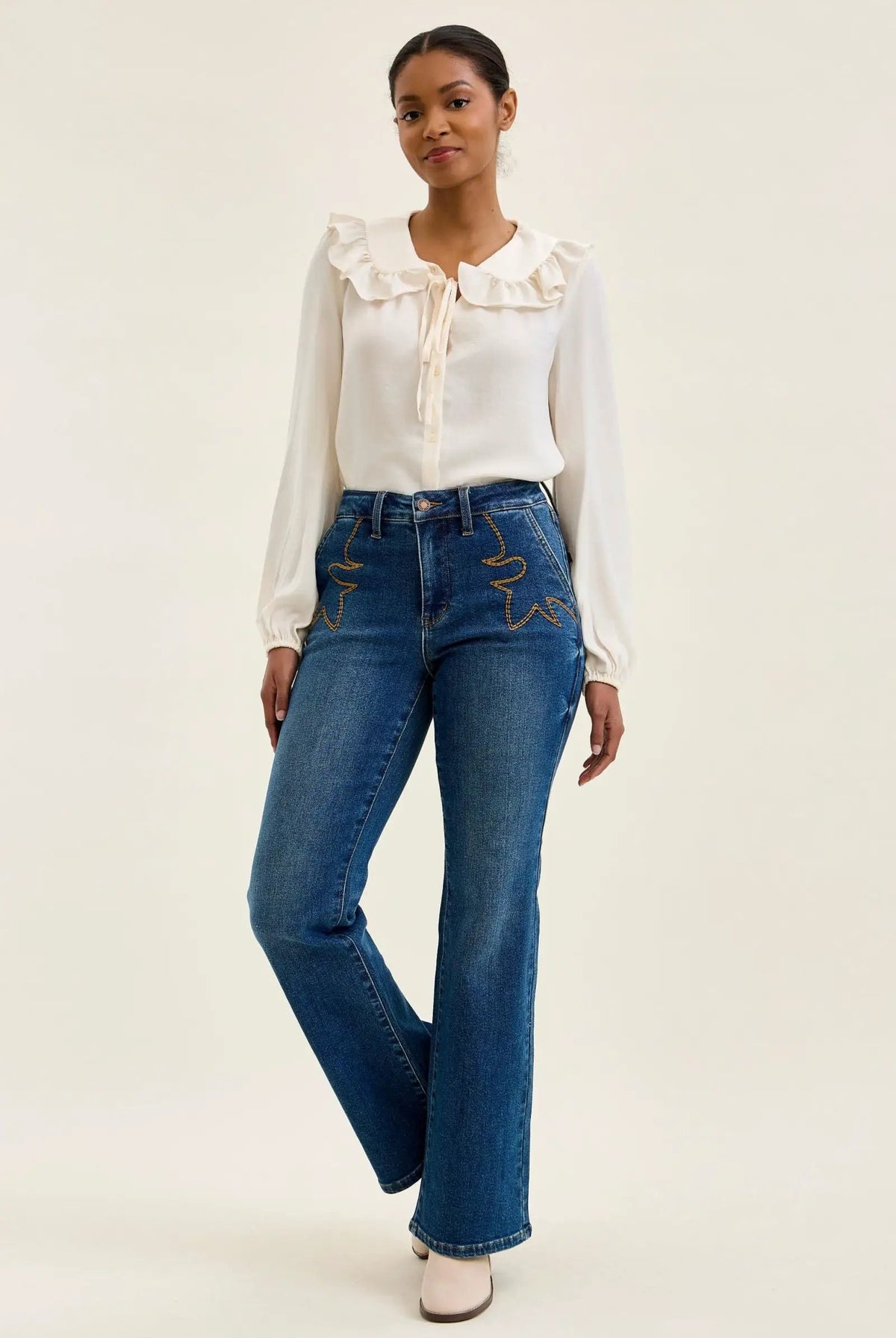 Judy Blue Daisy Mid-Rise Tummy-Control Bootcut Jeans with Western Stitching, blue denim with yellow pocket embroidery.