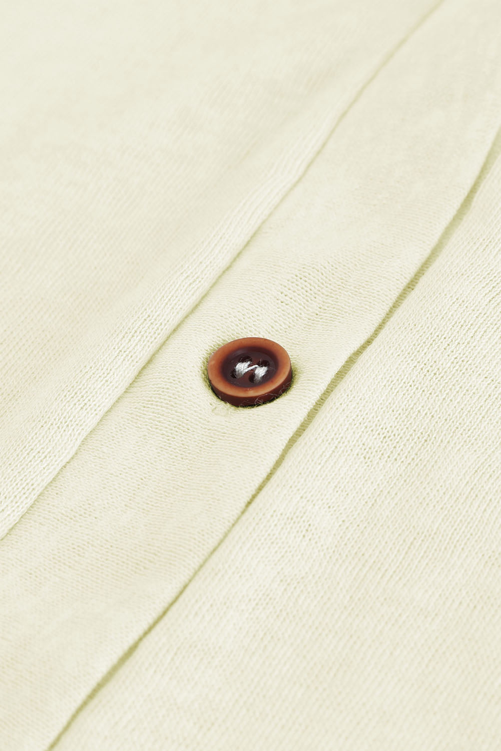 Close-up of cardigan buttons and breathable texture