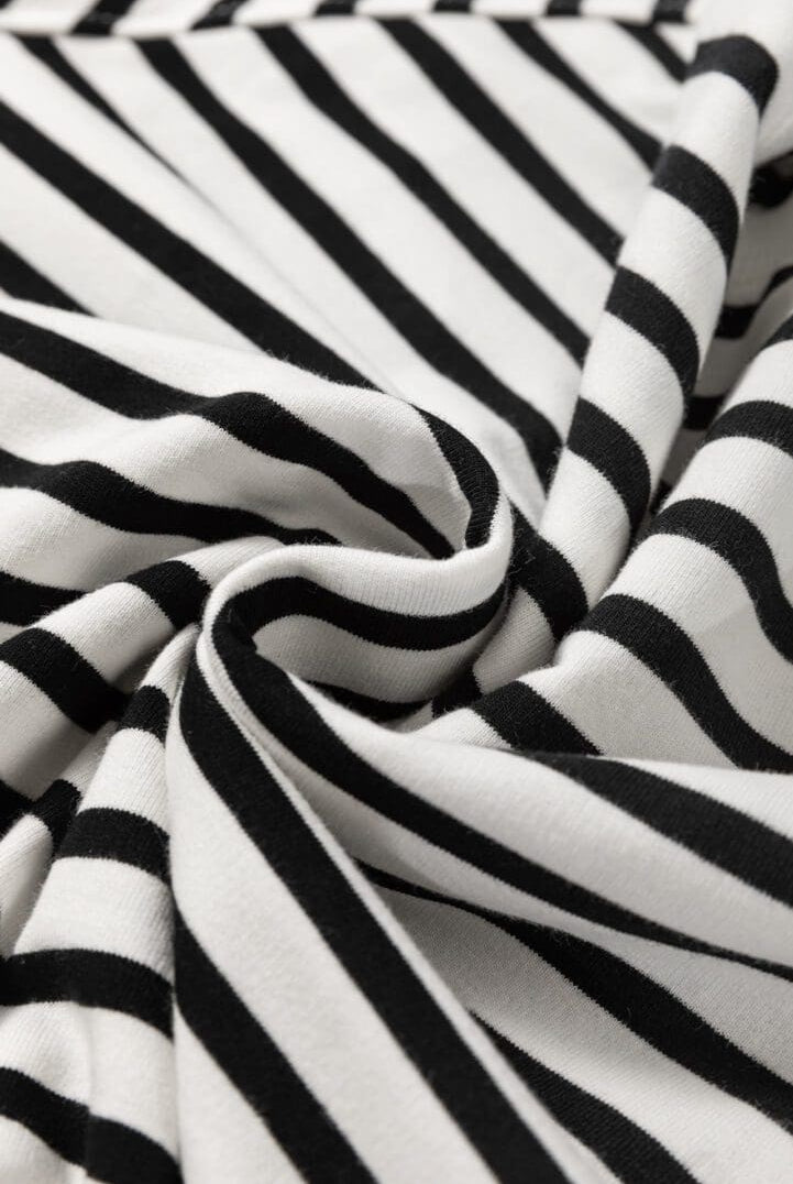 A close up of the fabric with black and white stripes