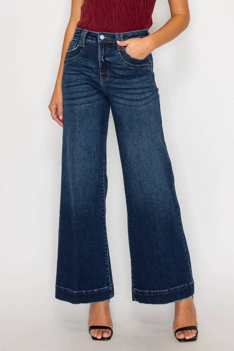 Artemis Vintage tummy-control high-rise A-line wide-leg jeans in dark stone wash, flattering elongated silhouette.