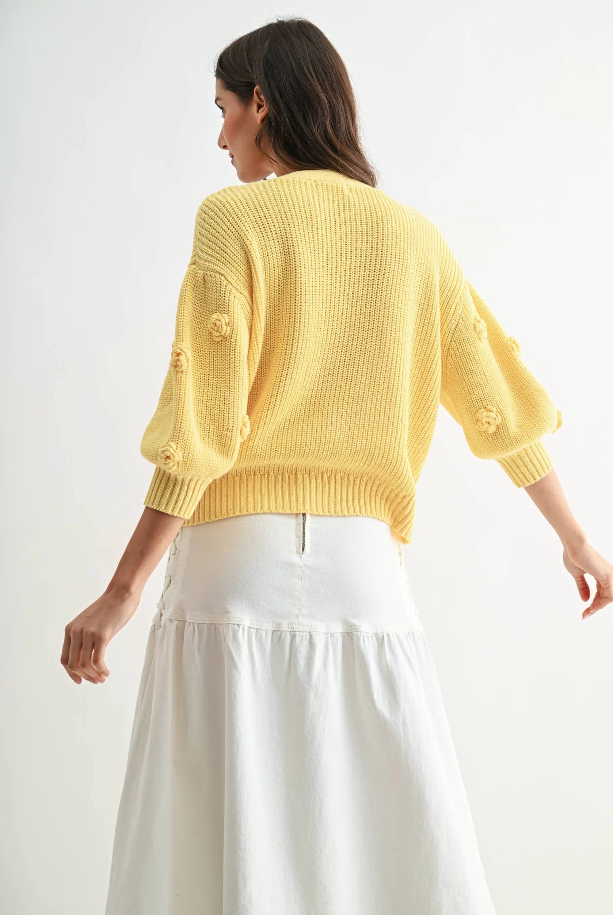 LT.YELLOW textured knit cardigan with 3D floral accents, back view.