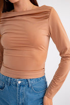 Here's an alt tag for the image: Brown long-sleeve fitted top.