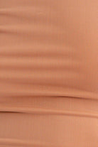 Close-up of light brown fabric texture.