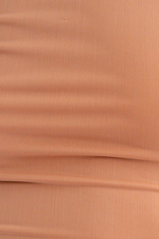 Close-up of light brown fabric texture.