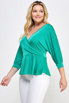 Here's an alt tag for the image: Green wrap peasant blouse.