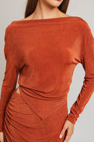 Here's an alt tag for the image: Rust-colored draped long-sleeve mini dress.