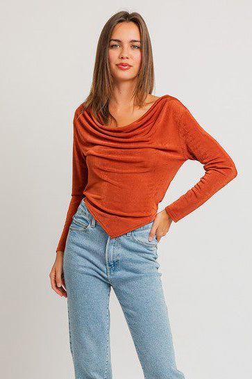 Woman in orange top and jeans.