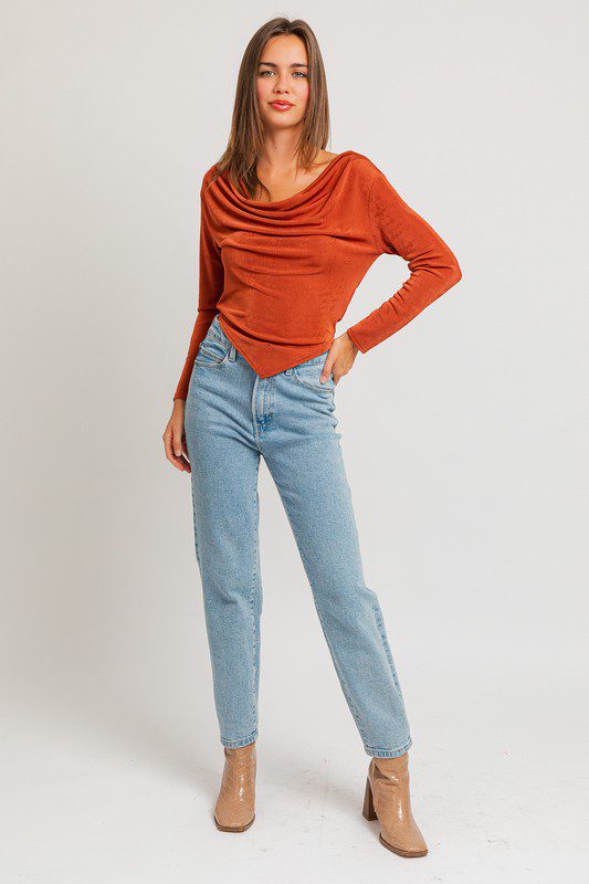 Woman in orange top and jeans.