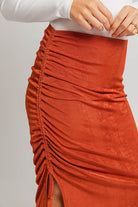 Rust side-tied ruched midi skirt.