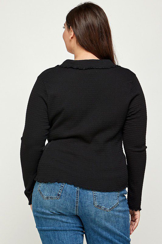 Black long-sleeve waffle knit top, back view.