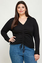 Plus-size black cinched long-sleeve top.