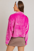 Pink fuzzy cropped zip-up jacket.