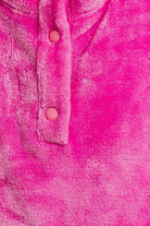 Pink fuzzy pullover, button detail.