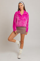 Woman in pink fuzzy cropped sweater and mini skirt.