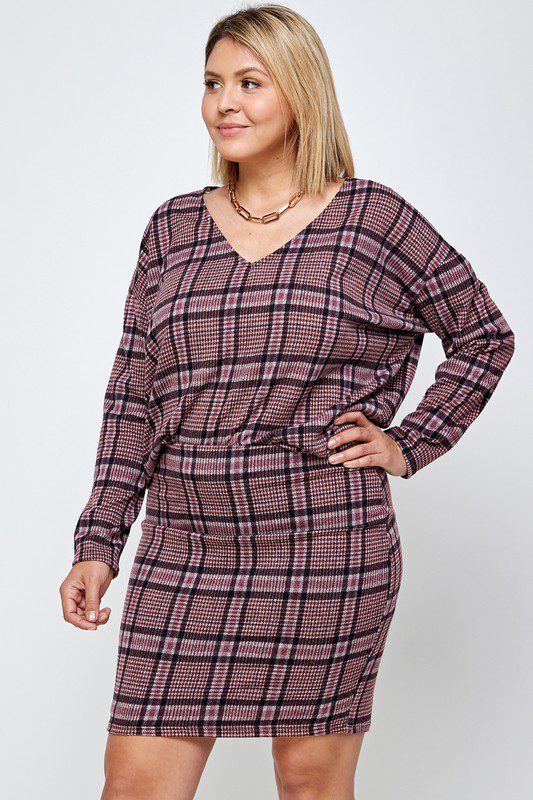 Plus-size model in plaid sweater and skirt.