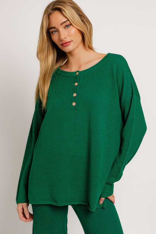 Green henley knit sweater and pants set.