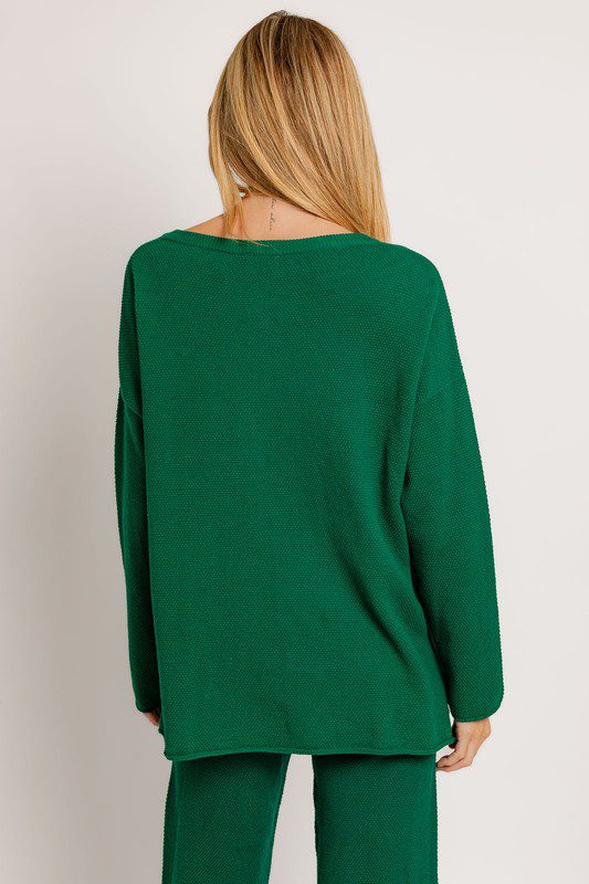 Here's an alt tag for the image: Green textured knit sweater and pants.