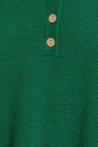 Green knitted sweater with buttons.