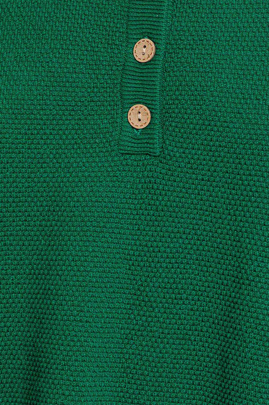 Green knitted sweater with buttons.