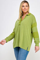 Woman in olive green collared sweater.