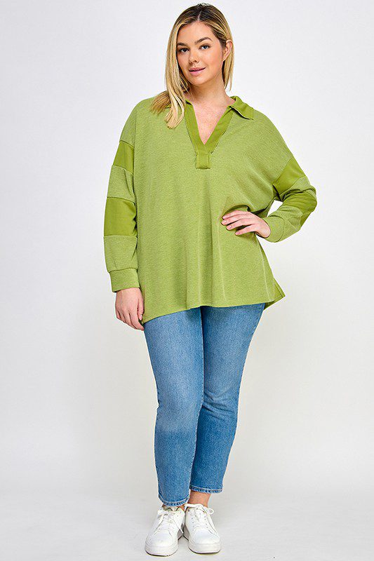 Woman in green collared shirt and jeans.