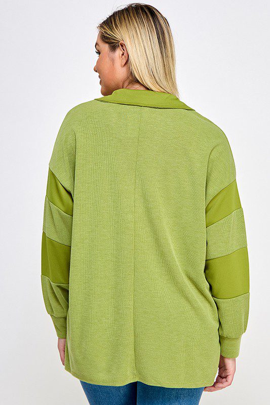 Green long-sleeve collared sweater.