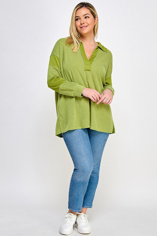 Woman in green collared shirt and jeans.