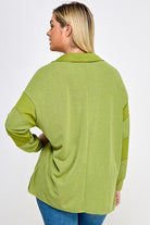 Green collared long-sleeve top, back view.