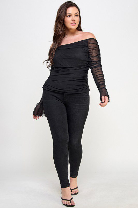 Woman in black mesh top and jeans.