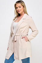 Beige cinched waist long blazer.