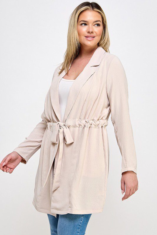 Beige belted long sleeve blazer.