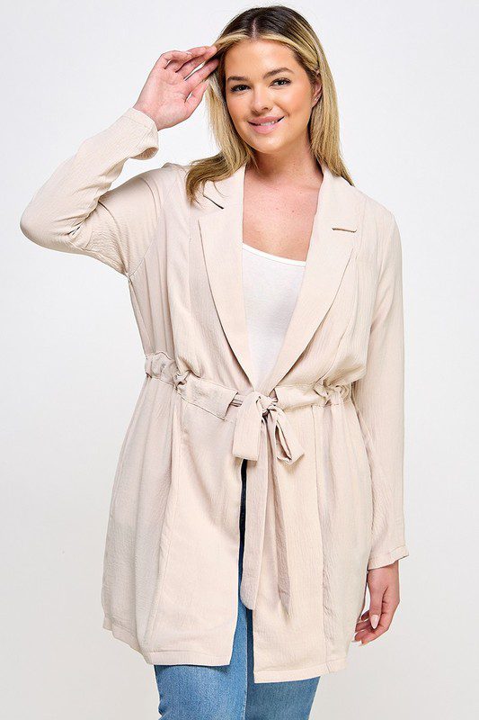 Beige belted long sleeve jacket.