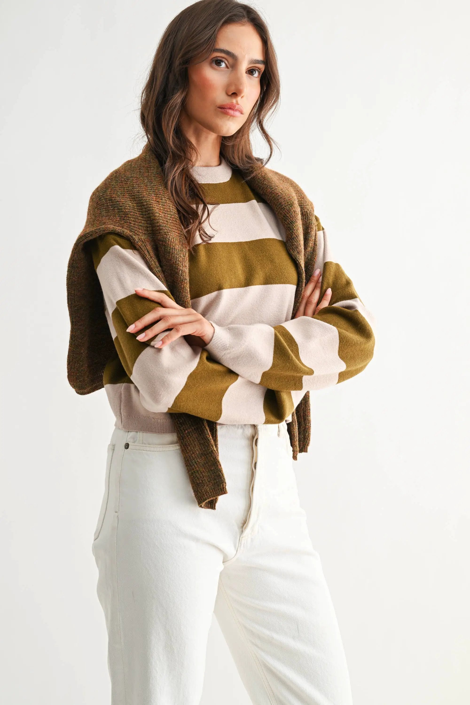 Light taupe and olive bold stripe crewneck sweater with wide horizontal stripes on a model.